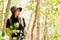 AsianÂ woman exploring forest green natural capturingÂ beauty nature outdoor.